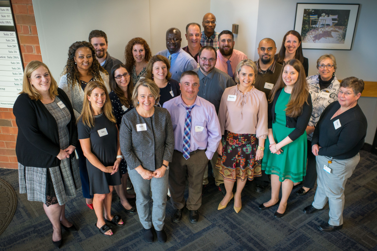 A group of professionals looks up at the camera