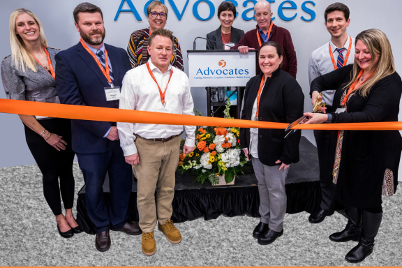 Cover of Annual Report featuring photo of ribbon cutting at Community Behavioral Health Center grand opening.