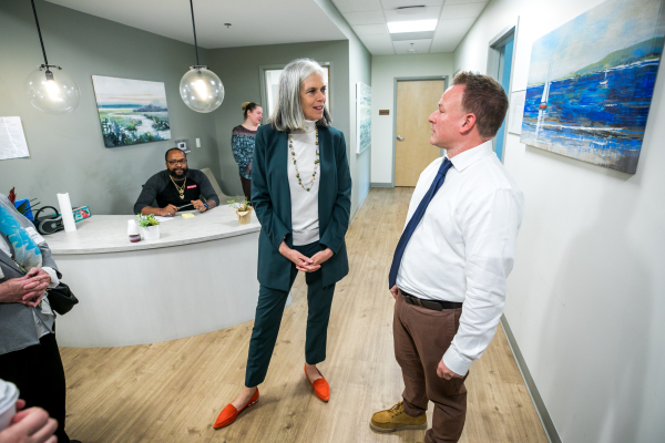 Congresswoman Clark speaks with a man in a collared shirt and tie
