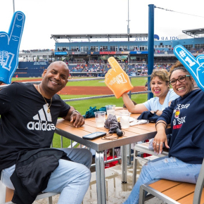 Three people holding #1 hand signs