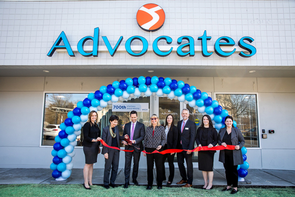 Group of people from Advocates and Genoa standing in front of Advocates Community Behavioral Health Center at the Genoa Pharmacy grand opening.
