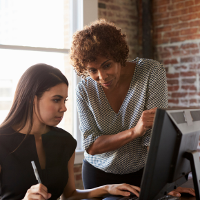 Adult with long hair learning to use a computer